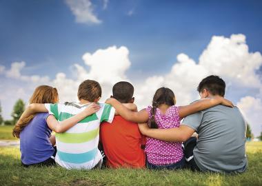 Kids sitting in a park