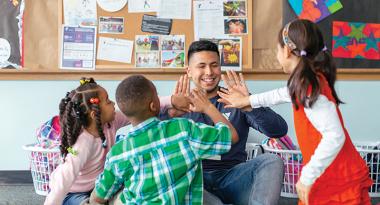 Youth and Kids Club staff exchange high fives