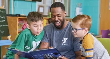 After school counselor and youth read together