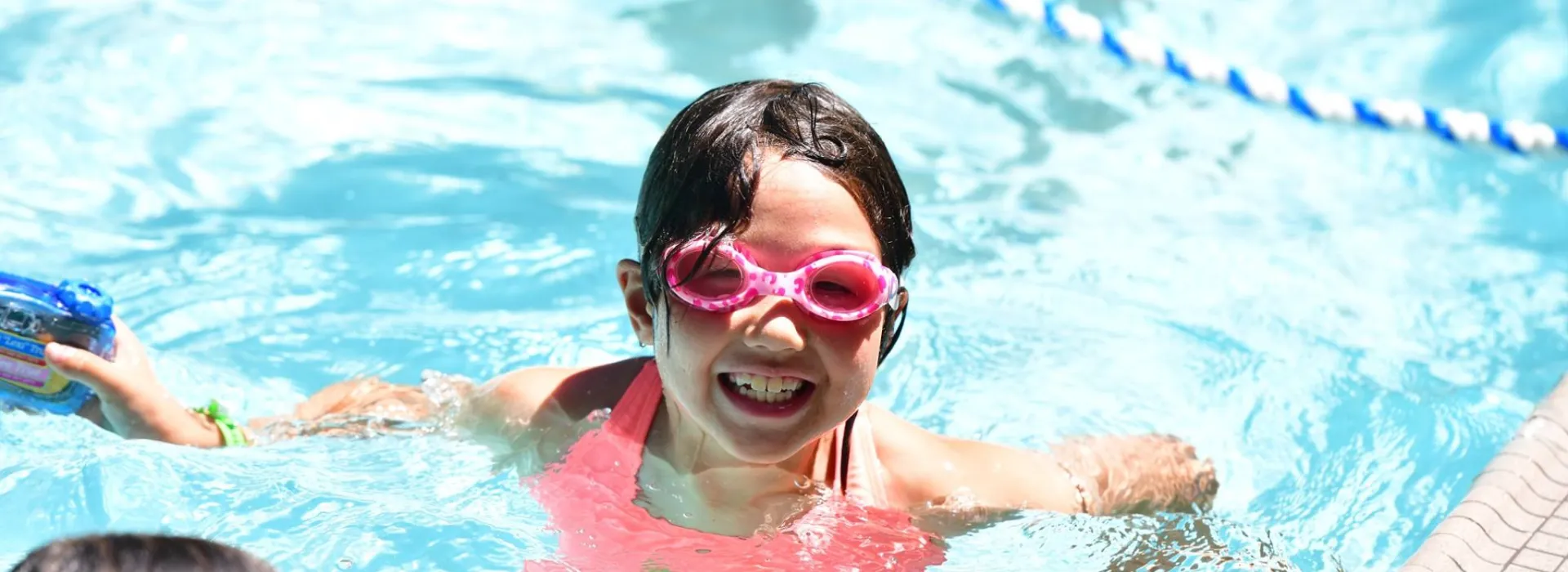 girl in pool smiling