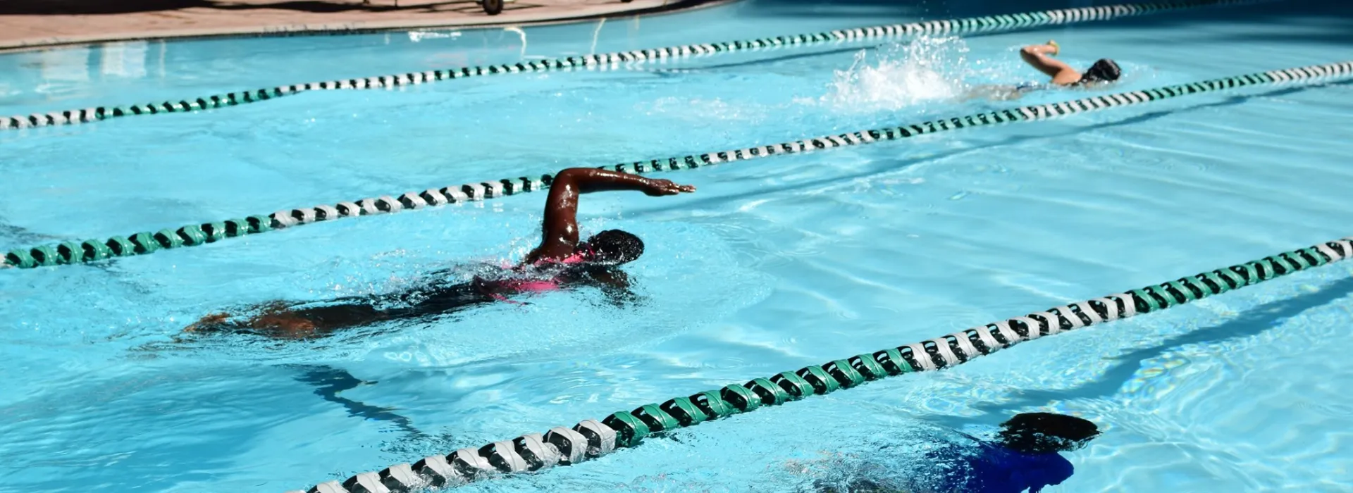 two people swimming in individual lanes